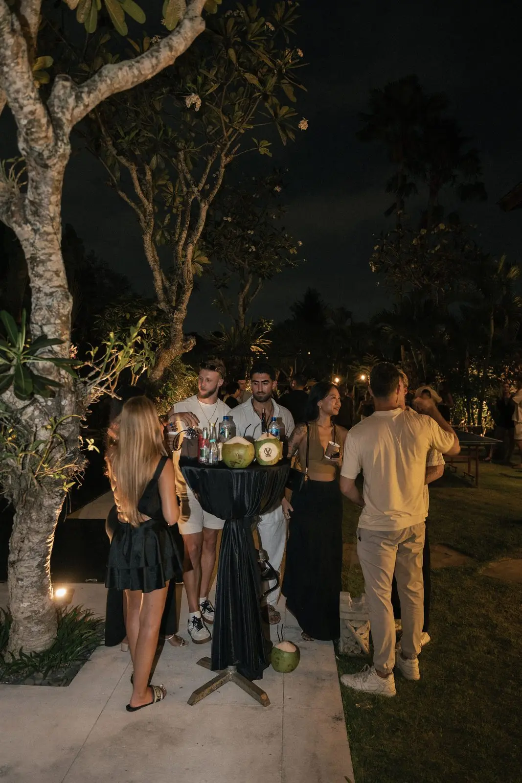 Guests talking under the frangipani tree