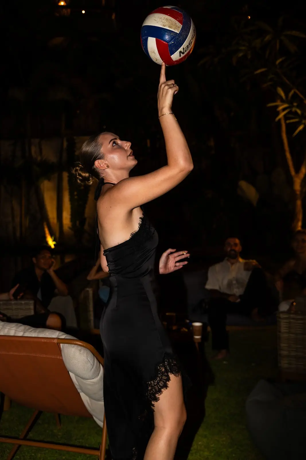 A guest spinning a volleyball on one finger